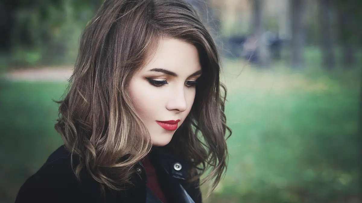 Lovely Girl in the Park. Pretty Woman with Long Bob Hairstyle