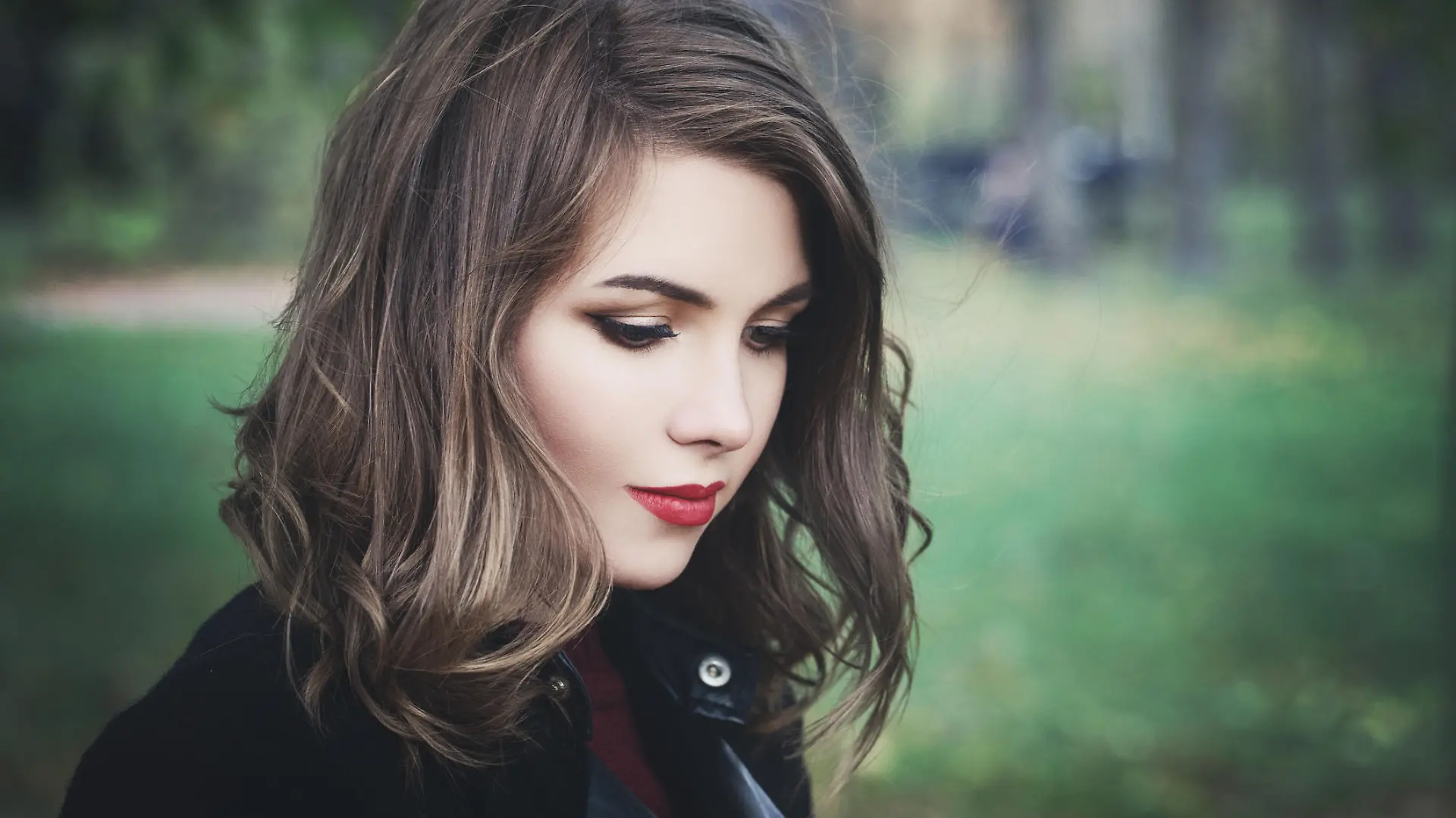 Lovely Girl in the Park. Pretty Woman with Long Bob Hairstyle