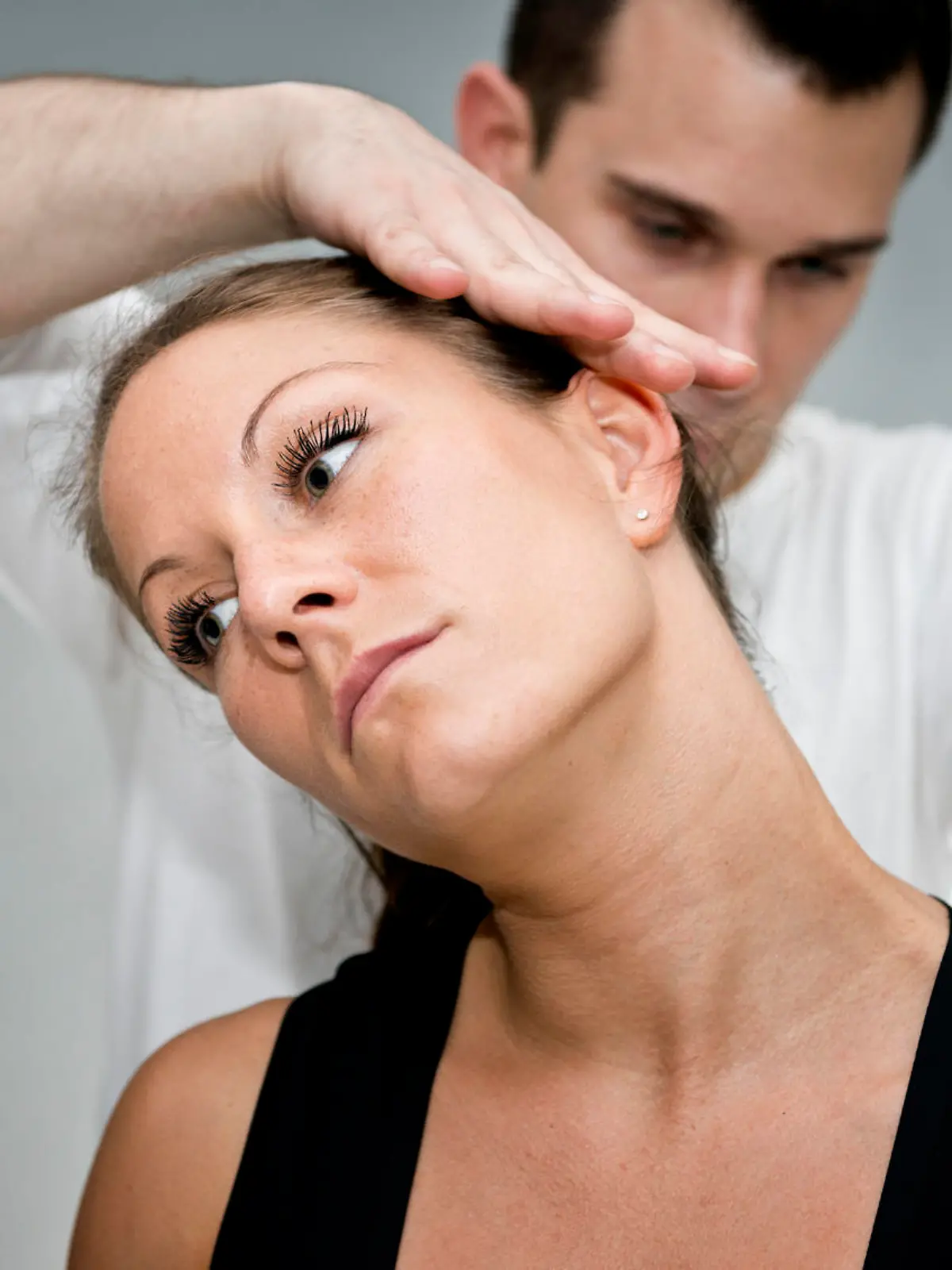 Chiropractic adjustment - Chriopractor working on patient's neck