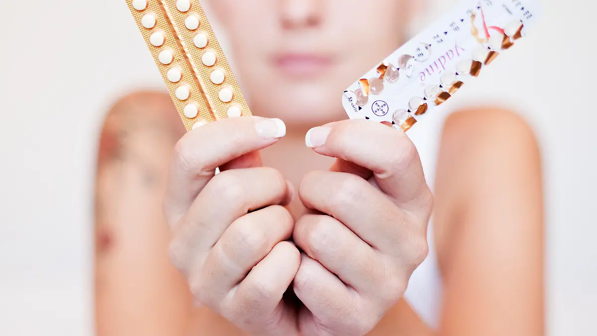 Young woman with contraceptive pills, birth-control pill, blister pack of combined oral contraceptive pills, birth control, prevention of pregnancy. (CTK Photo/Josef Horazny, Martin Sterba)