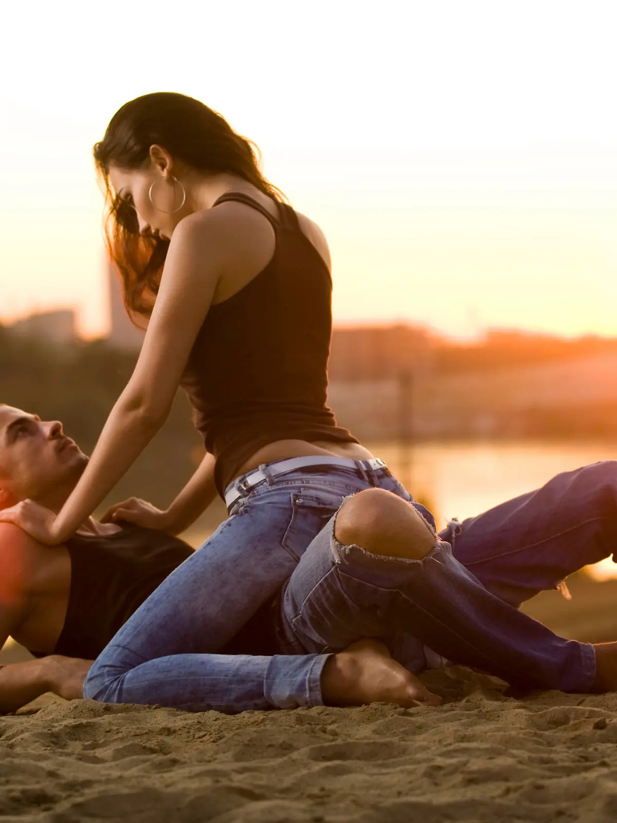 Pair in jeans on a sunset