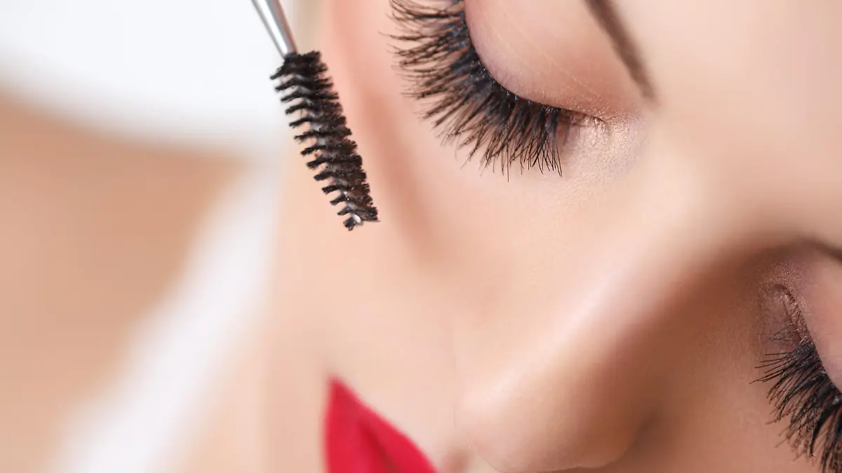 Woman eye with beautiful makeup and long eyelashes. Mascara Brush. High quality image.