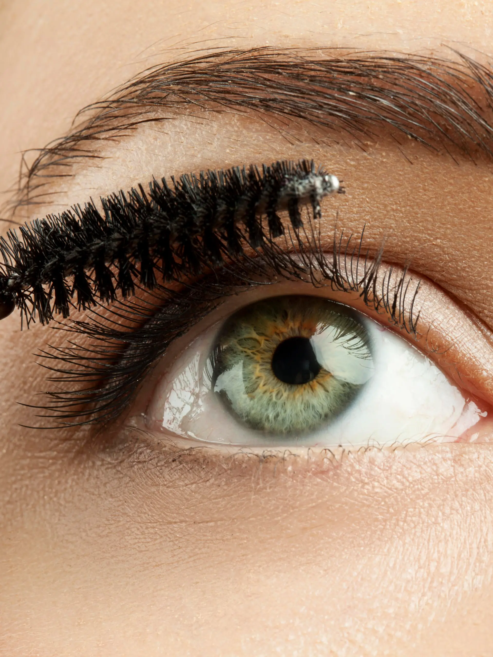Close-up of make-up green eye with long lashes with black mascara