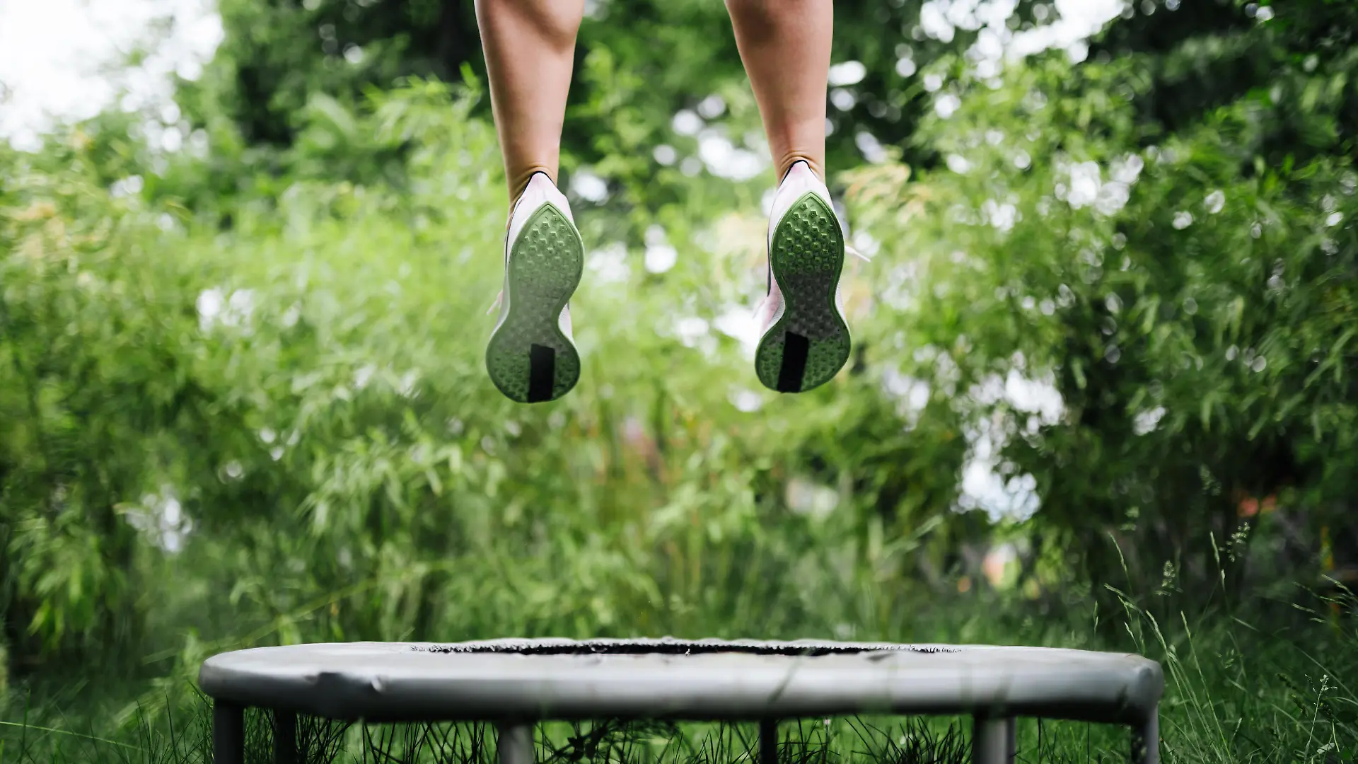 a sport woman jumping on a trampoline