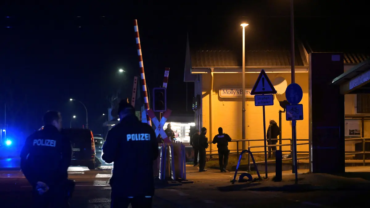 Police officers work at a railway station after an incident involving a knife attack took place on a train travelling between Kiel and Hamburg, in Brokstedt, Germany, January 25, 2023. REUTERS/Fabian Bimmer