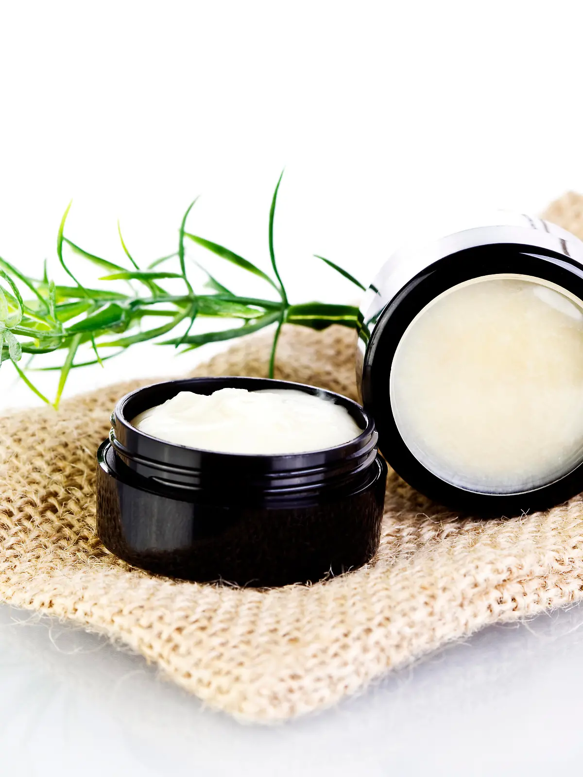 Natural lip balm and skin salve made with organic oils and butters in black tin