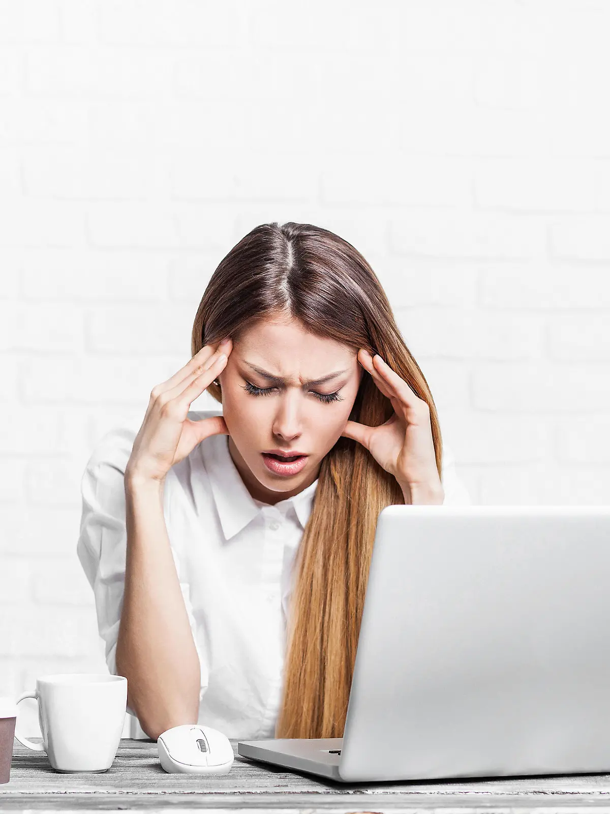 Young businesswoman having headache at work