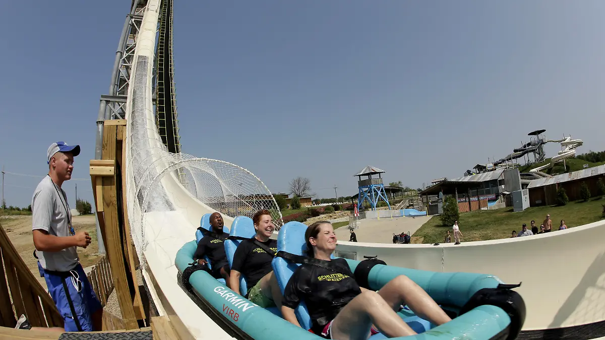 In this photo taken with a fisheye lens, riders go down the world's tallest water slide called "Verruckt" at Schlitterbahn Waterpark, Wednesday, July 9, 2014, in Kansas City, Kan. The 168-foot-tall waterslide is scheduled to open to the public Thursday, after initially being slated to open May 23. (AP Photo/Charlie Riedel) |