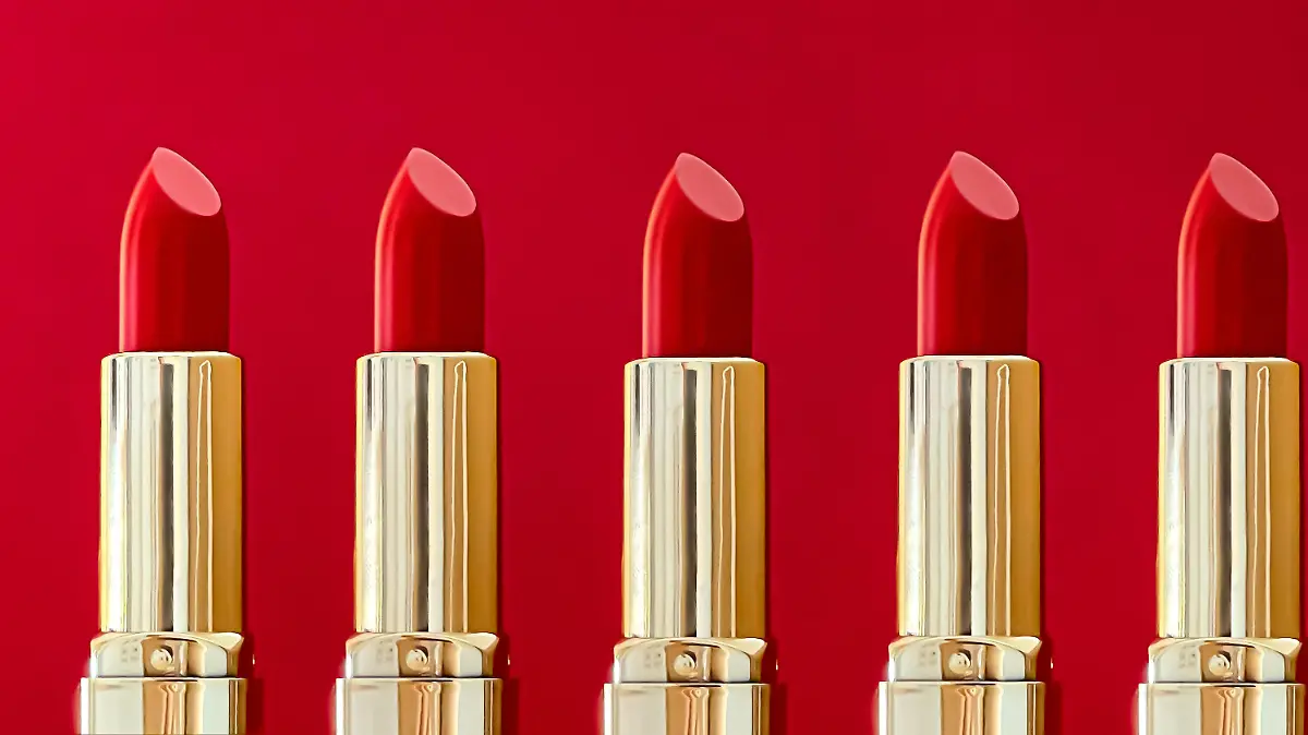 Red lipstick in golden tubes on colour background, luxury make-up and cosmetics for beauty brand product design concept