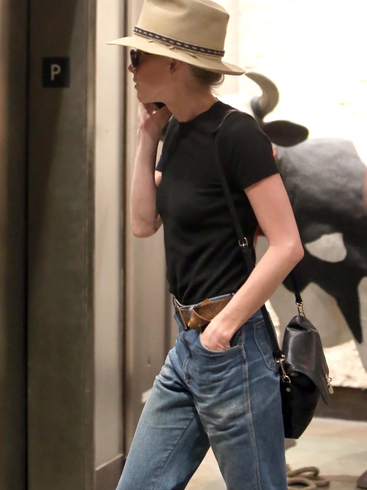 Amber Heard arrives at an office building in Los Angeles, California. Johnny Depp's estranged wife covered up with a hat and sunglasses as she entered the building, talking on her phone.