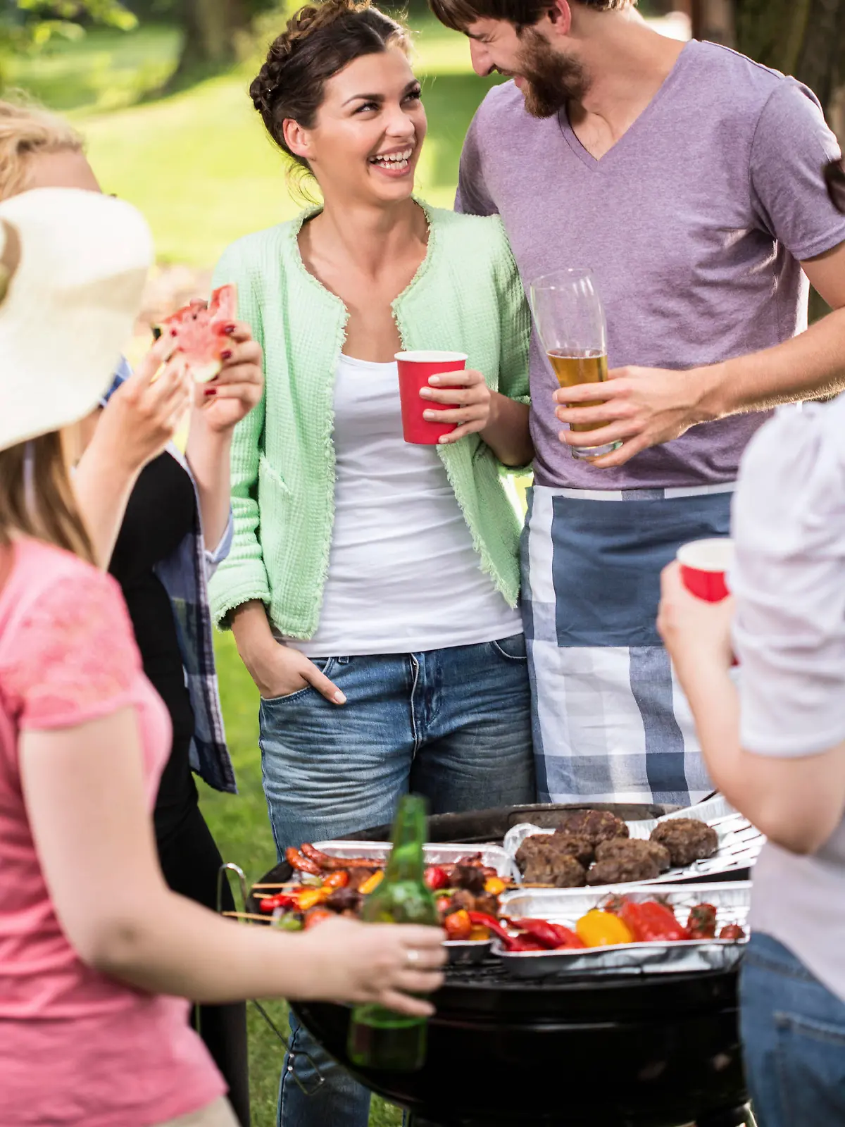 Young couple laughing at the barbecue party 