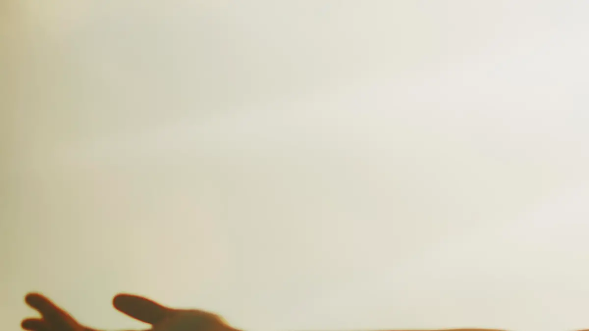 Young woman with arms raised.