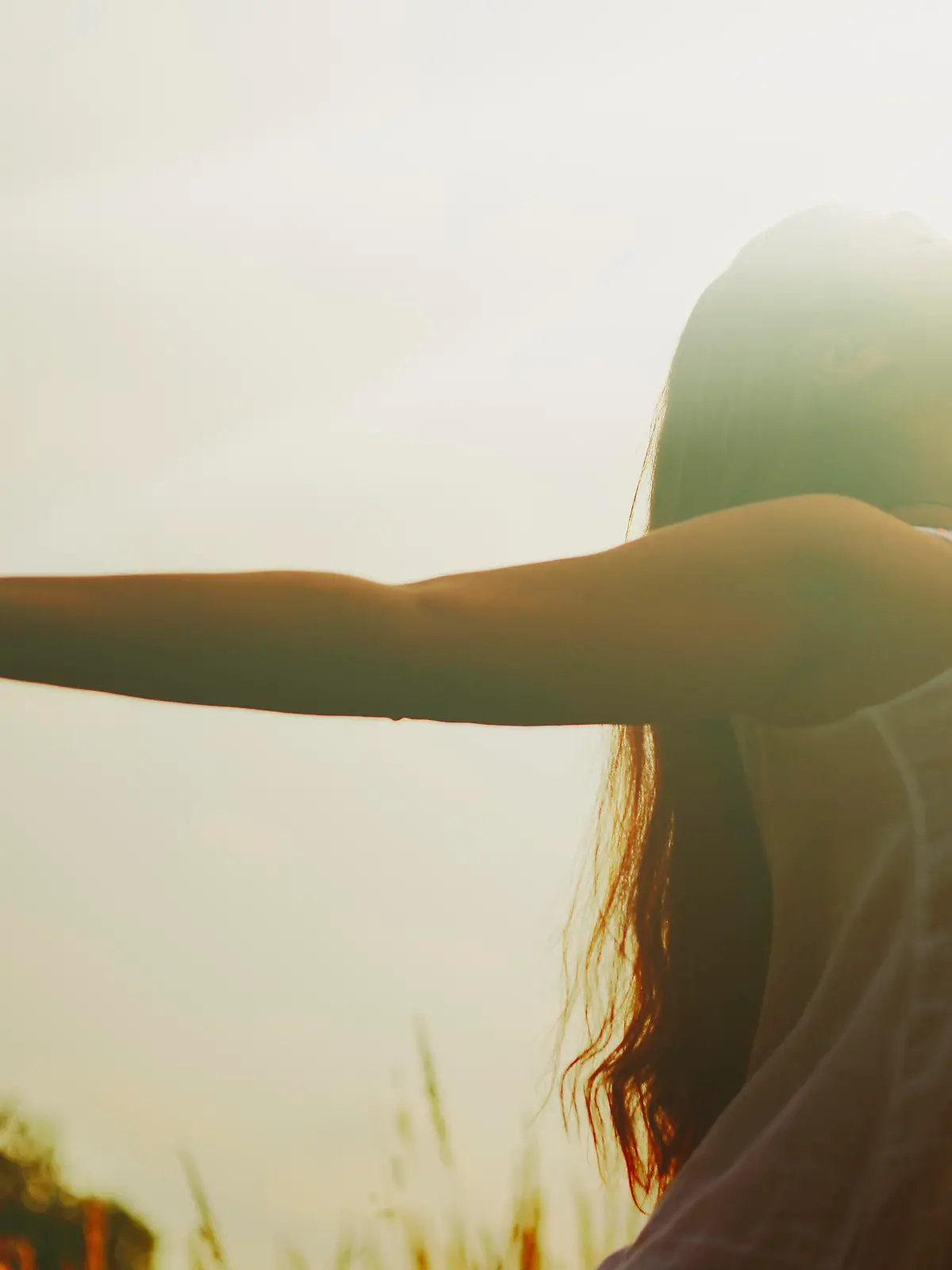 Young woman with arms raised.