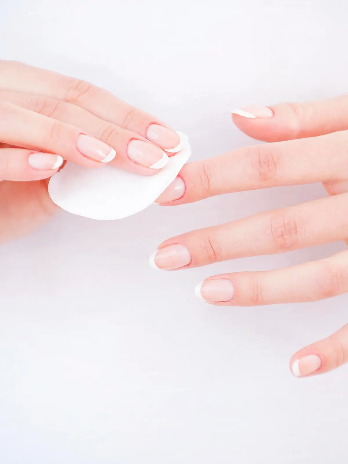 Nail care. Close-up of woman cleaning nails with cotton pad