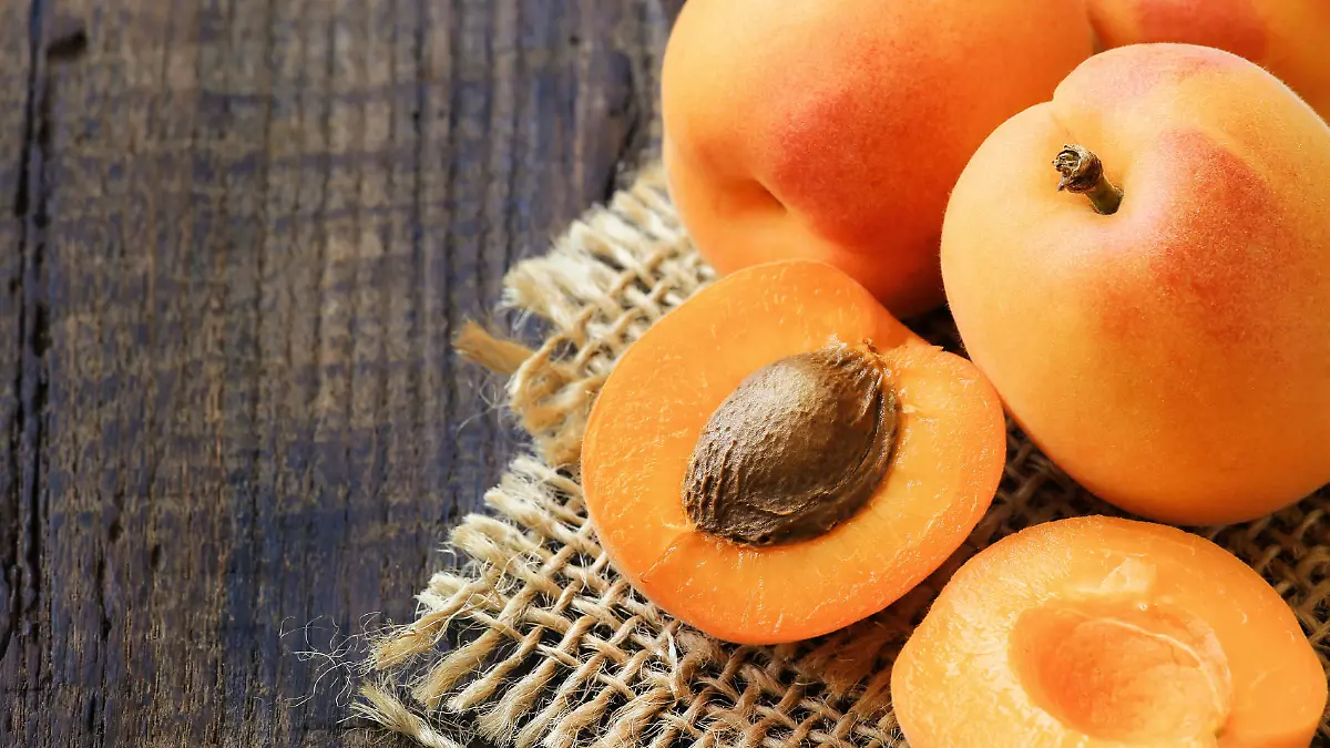 Fresh ripe apricots on a rustic wooden table