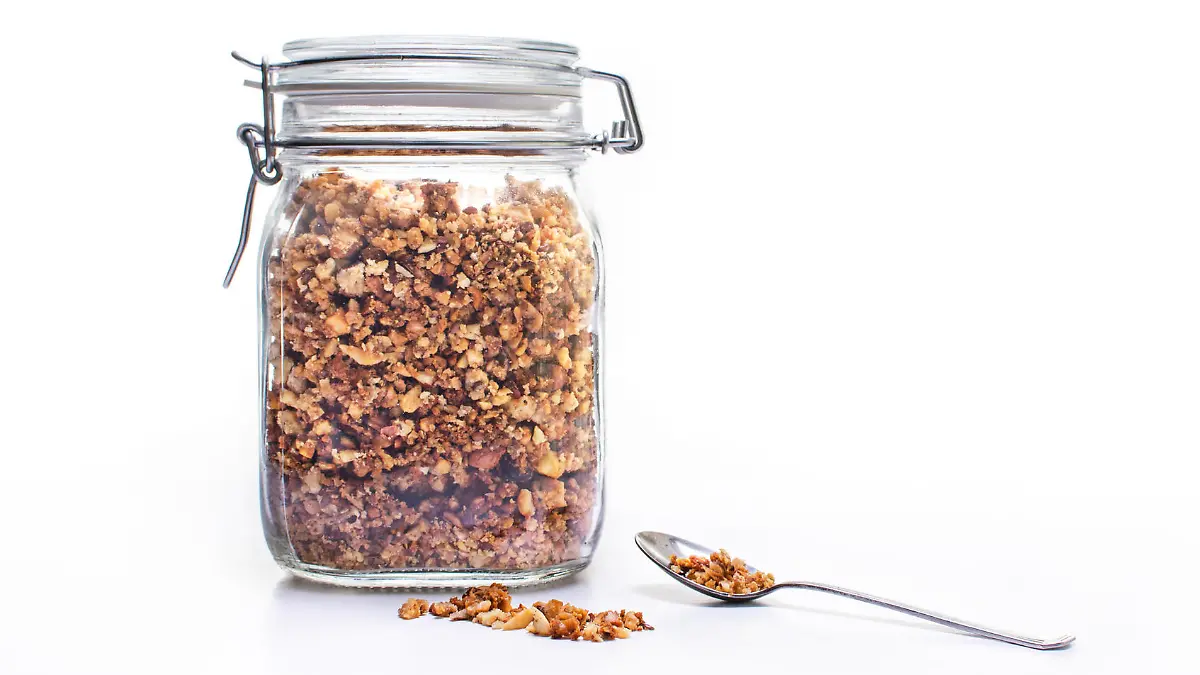 Glass jar of homemade granola with spoon