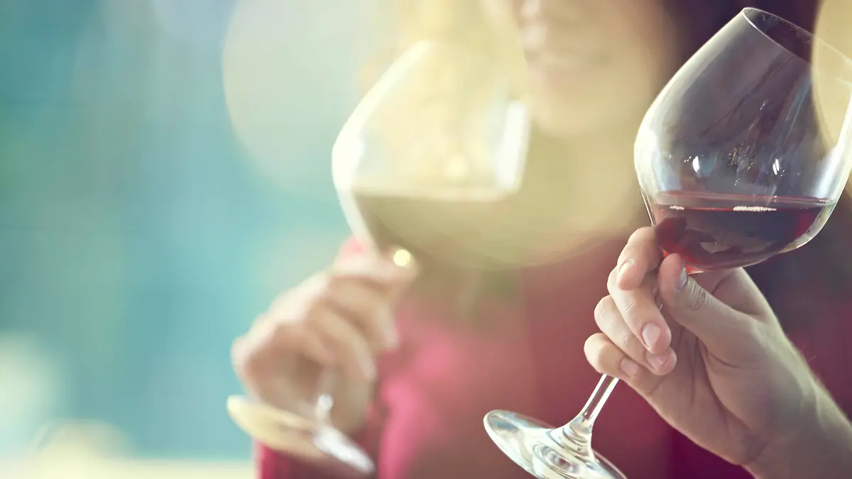 Close-up of people tasting red wine in glass 