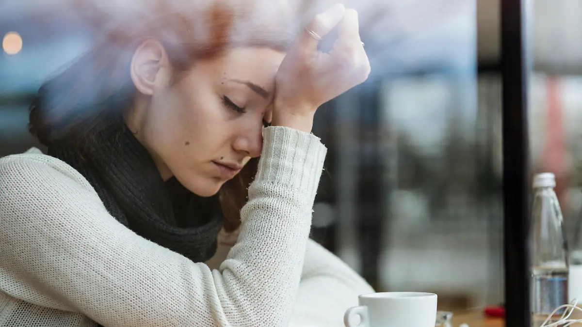 Young girl smoking and feeling depressed in a bar