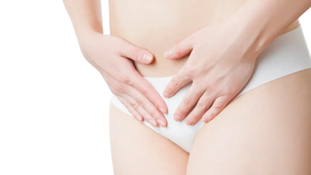 Pain in the abdomen. A girl in black panties.  Isolated on white background.
