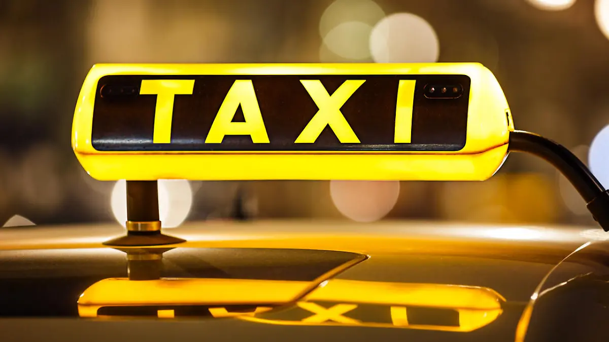 Illuminated Taxi sign on taxi car roof.
