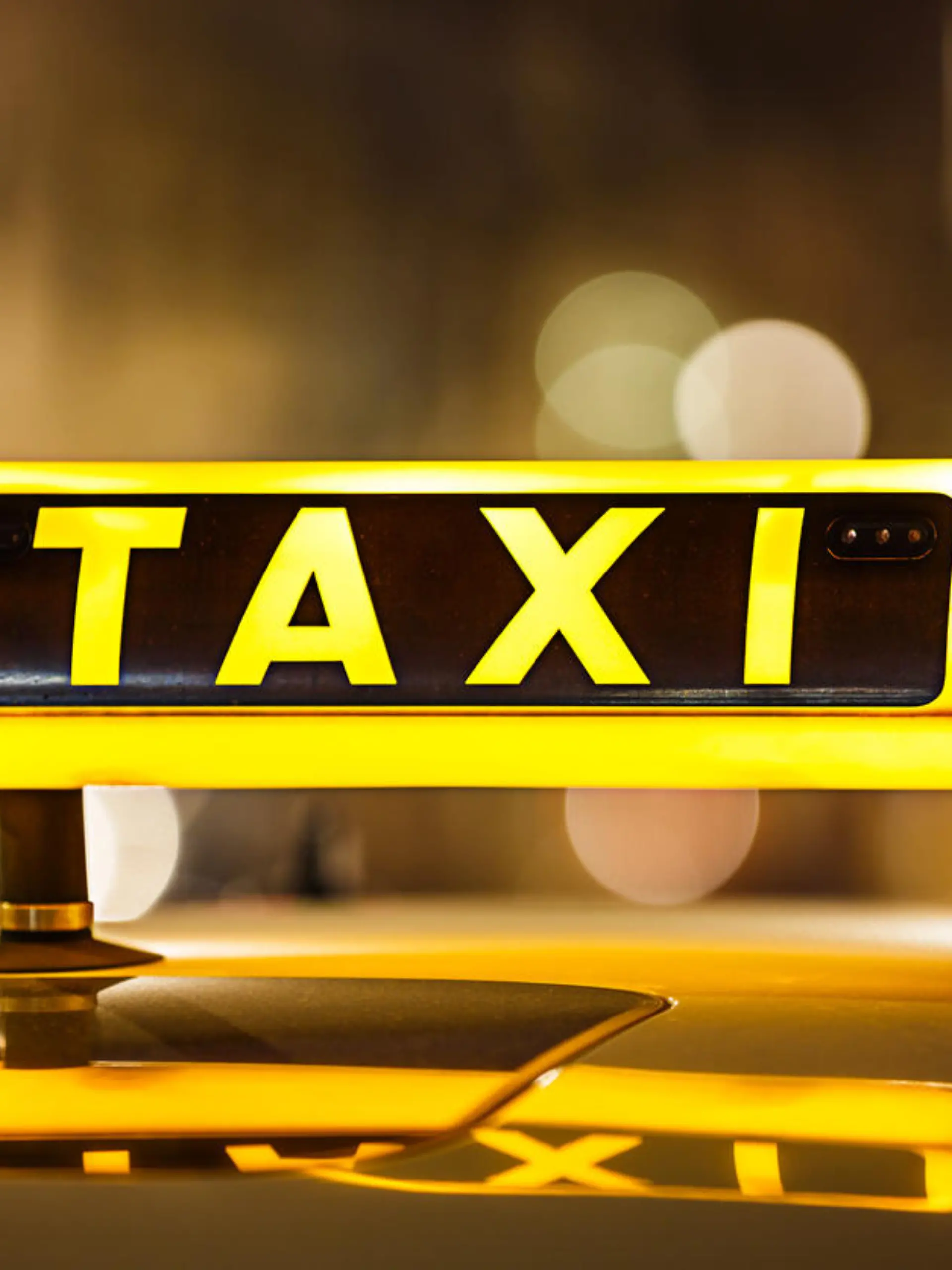 Illuminated Taxi sign on taxi car roof.