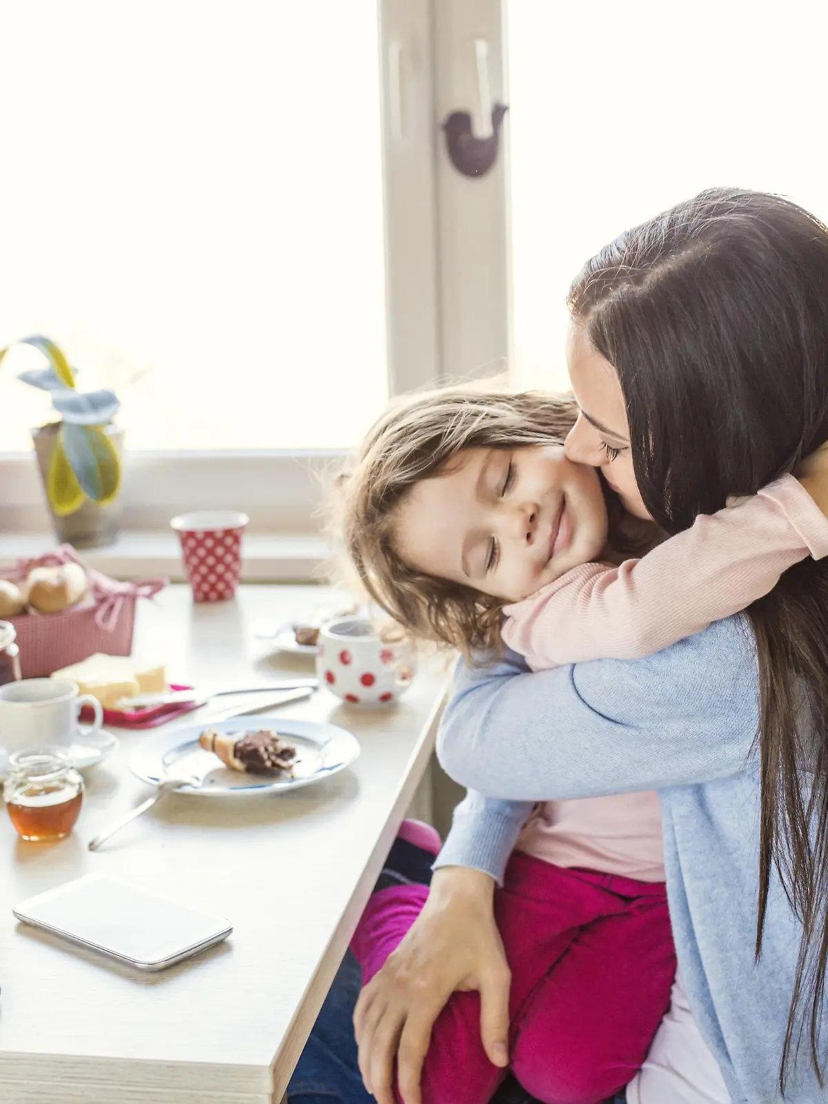 Portrait of smiling little girl hugging her mother at breakfast table model released Symbolfoto property released PUBLICATIONxINxGERxSUIxAUTxHUNxONLY HAPF000130Portrait of Smiling Little Girl HUGGING her Mother AT Breakfast Table Model released Symbolic image Property released PUBLICATIONxINxGERxSUIxAUTxHUNxONLY HAPF000130
