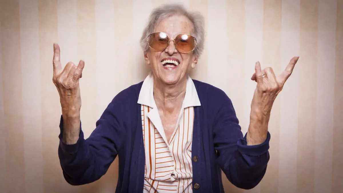 elder lady making rock on sign