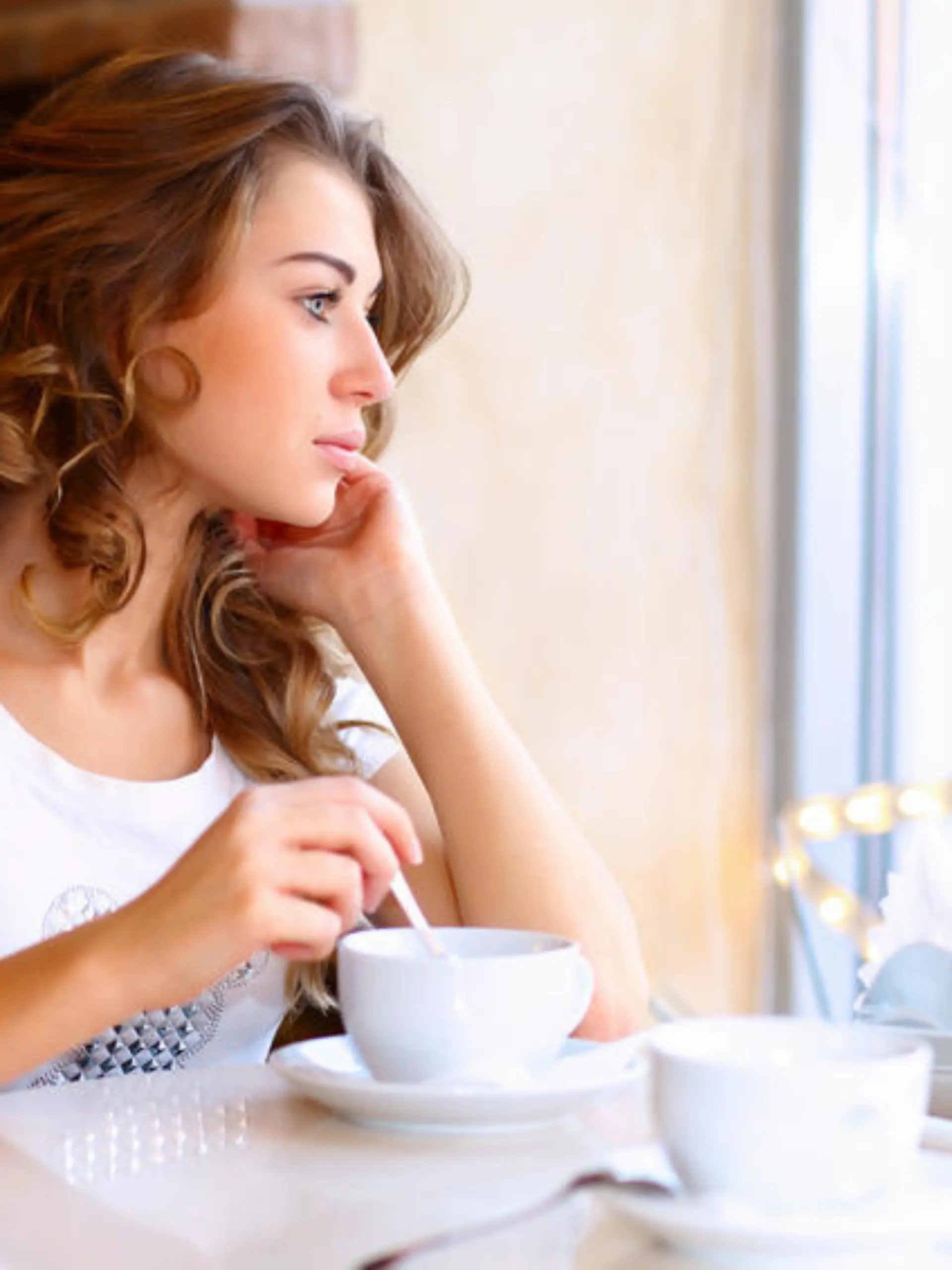 Portrait of young pretty woman sitting in restaurant