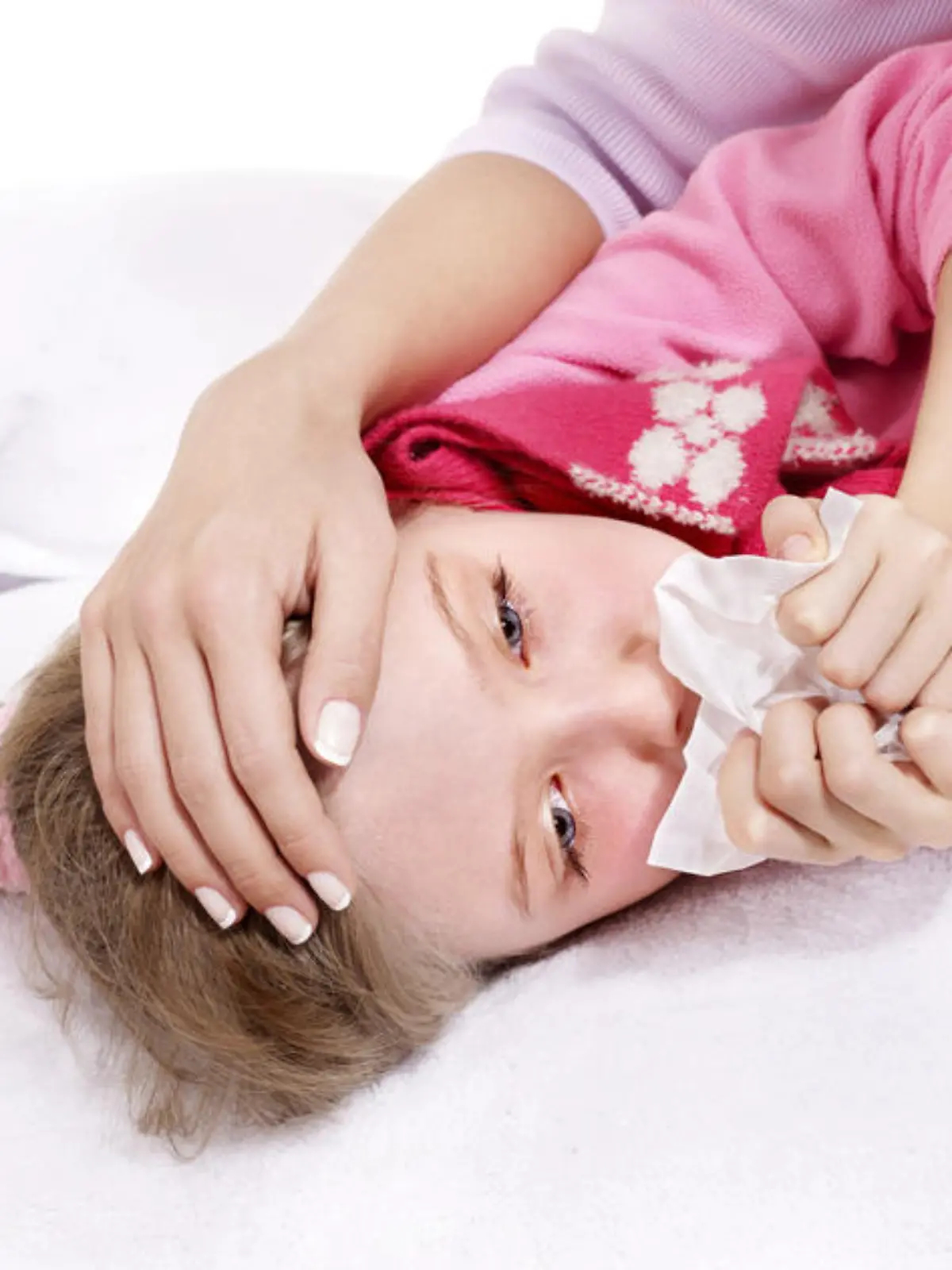 Sick little girl with handkerchief in bed.