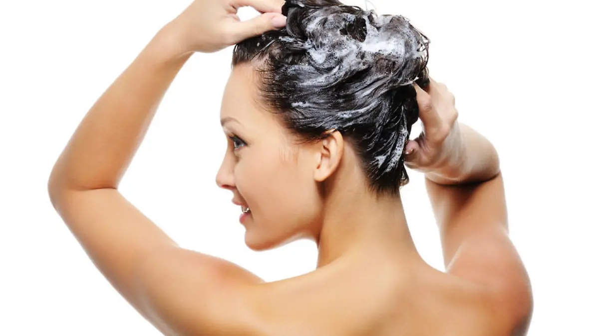 Portrait of young beautiful woman washing her head