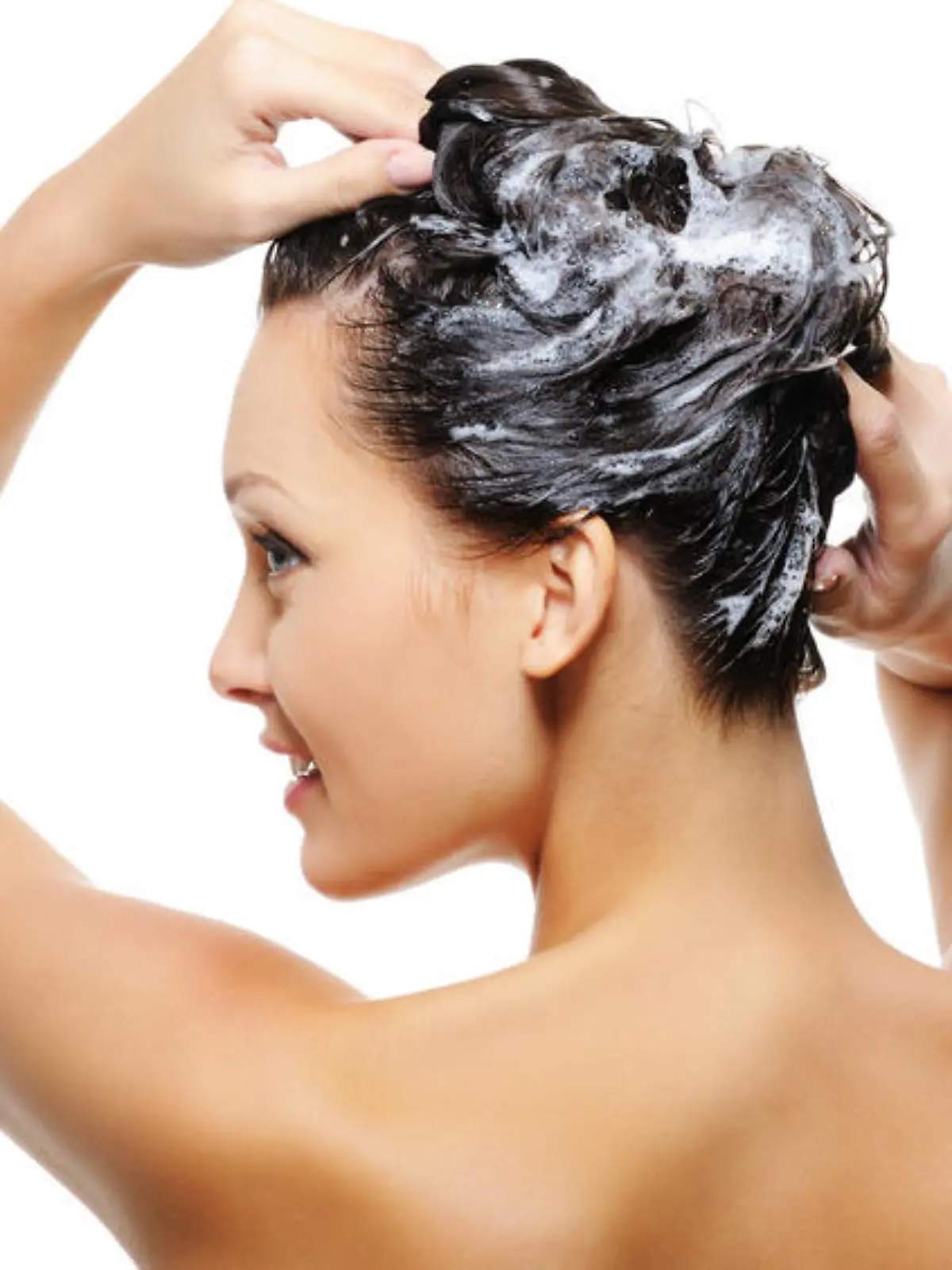 Portrait of young beautiful woman washing her head