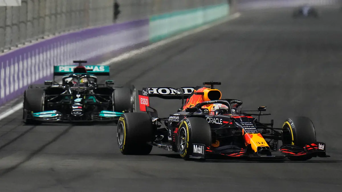 Red Bull driver Max Verstappen of the Netherlands, front, and Mercedes driver Lewis Hamilton of Britain in action t during the Formula One Saudi Arabian Grand Prix in Jiddah, Sunday, Dec. 5, 2021. (AP Photo/Hassan Ammar)
