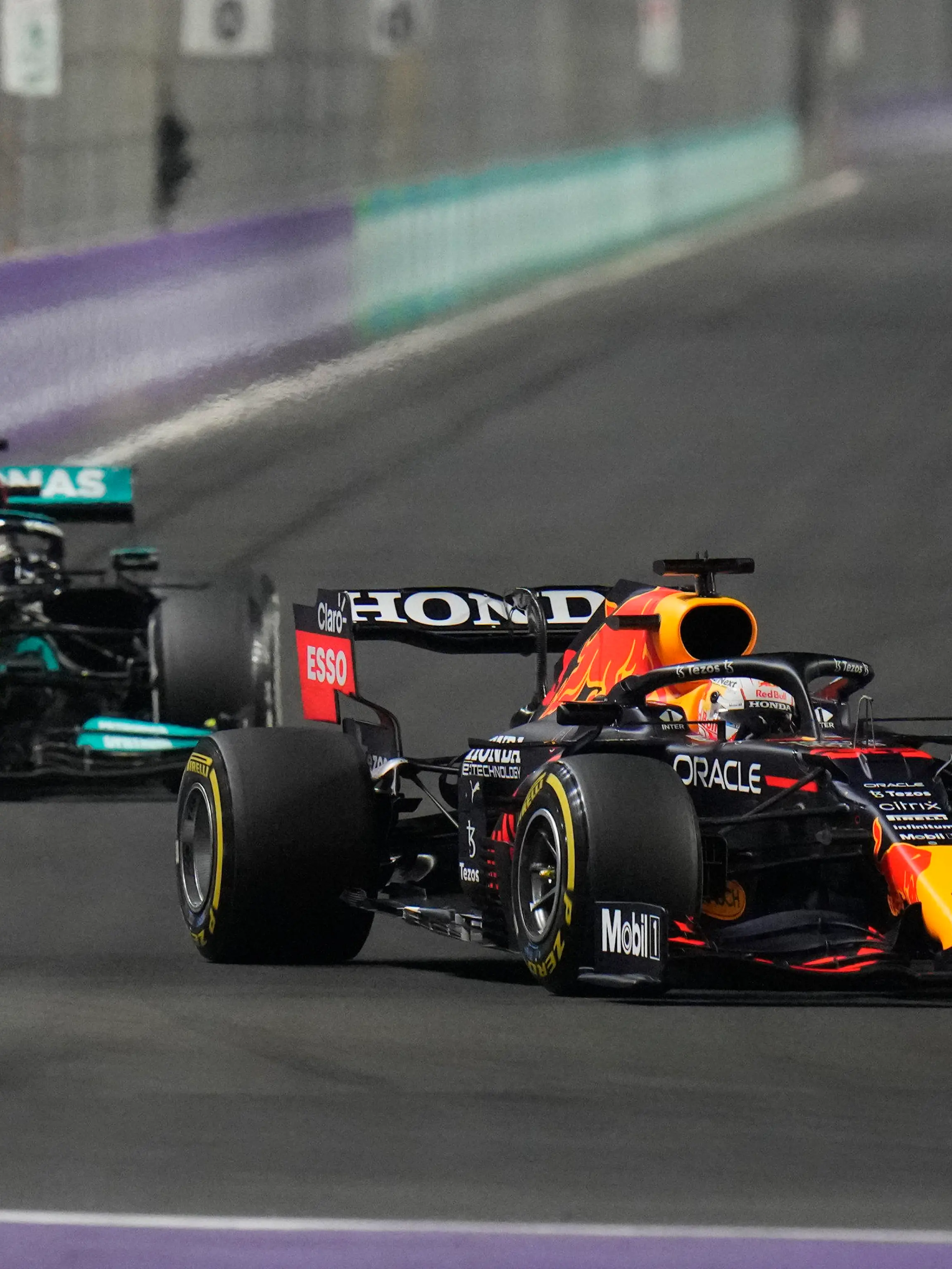 Red Bull driver Max Verstappen of the Netherlands, front, and Mercedes driver Lewis Hamilton of Britain in action t during the Formula One Saudi Arabian Grand Prix in Jiddah, Sunday, Dec. 5, 2021. (AP Photo/Hassan Ammar)
