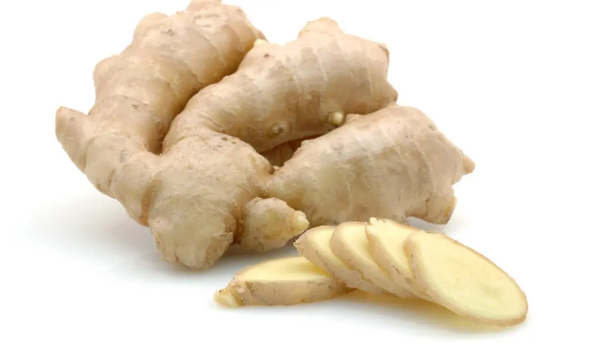 Whole and sliced ginger root in isolated white background