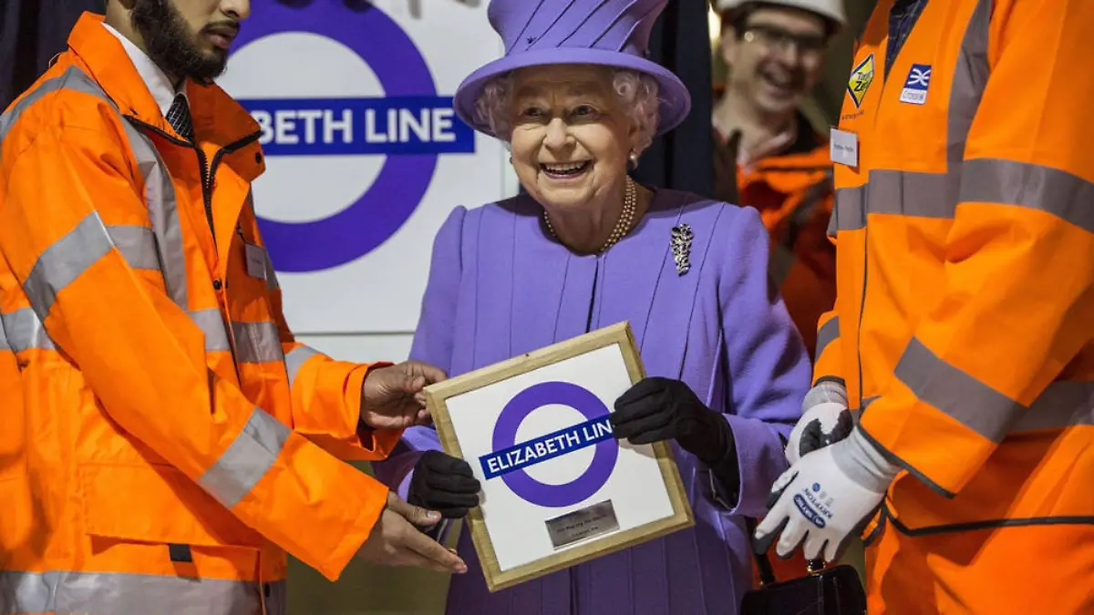 Stolz hält Queen Elizabeth II das Schild der neuen U-Bahn-Linie mit ihrem Namen hoch