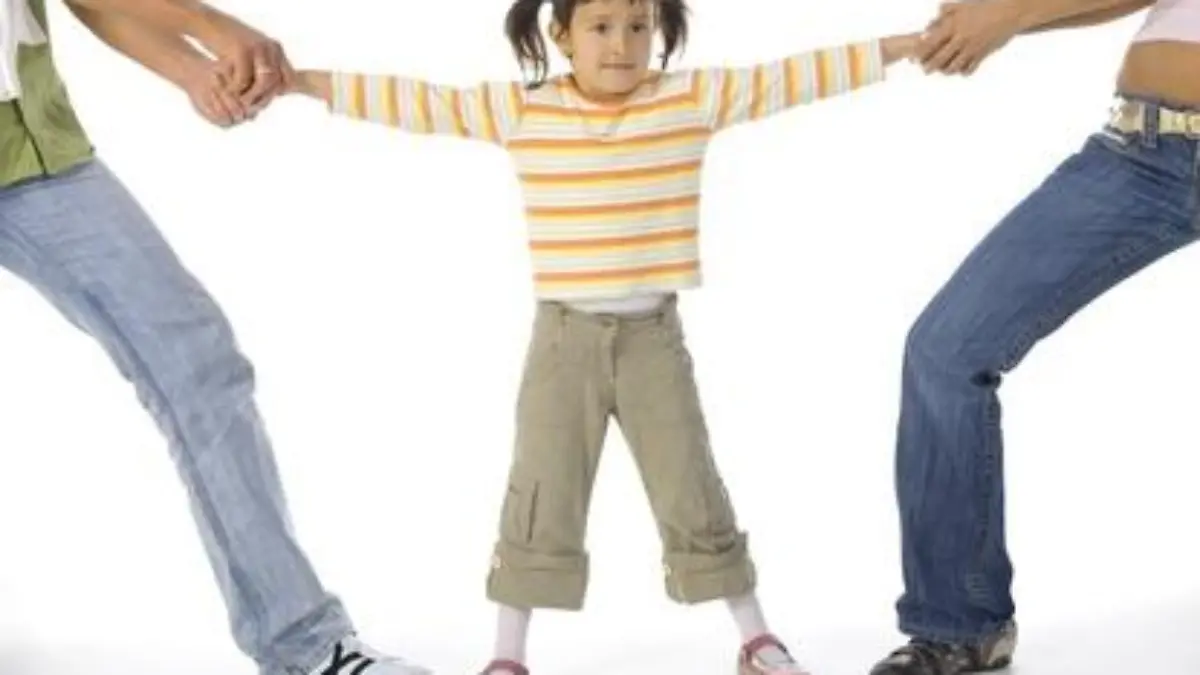 Man and woman quarrelling about little, confused girl. White background, whole body of little girl