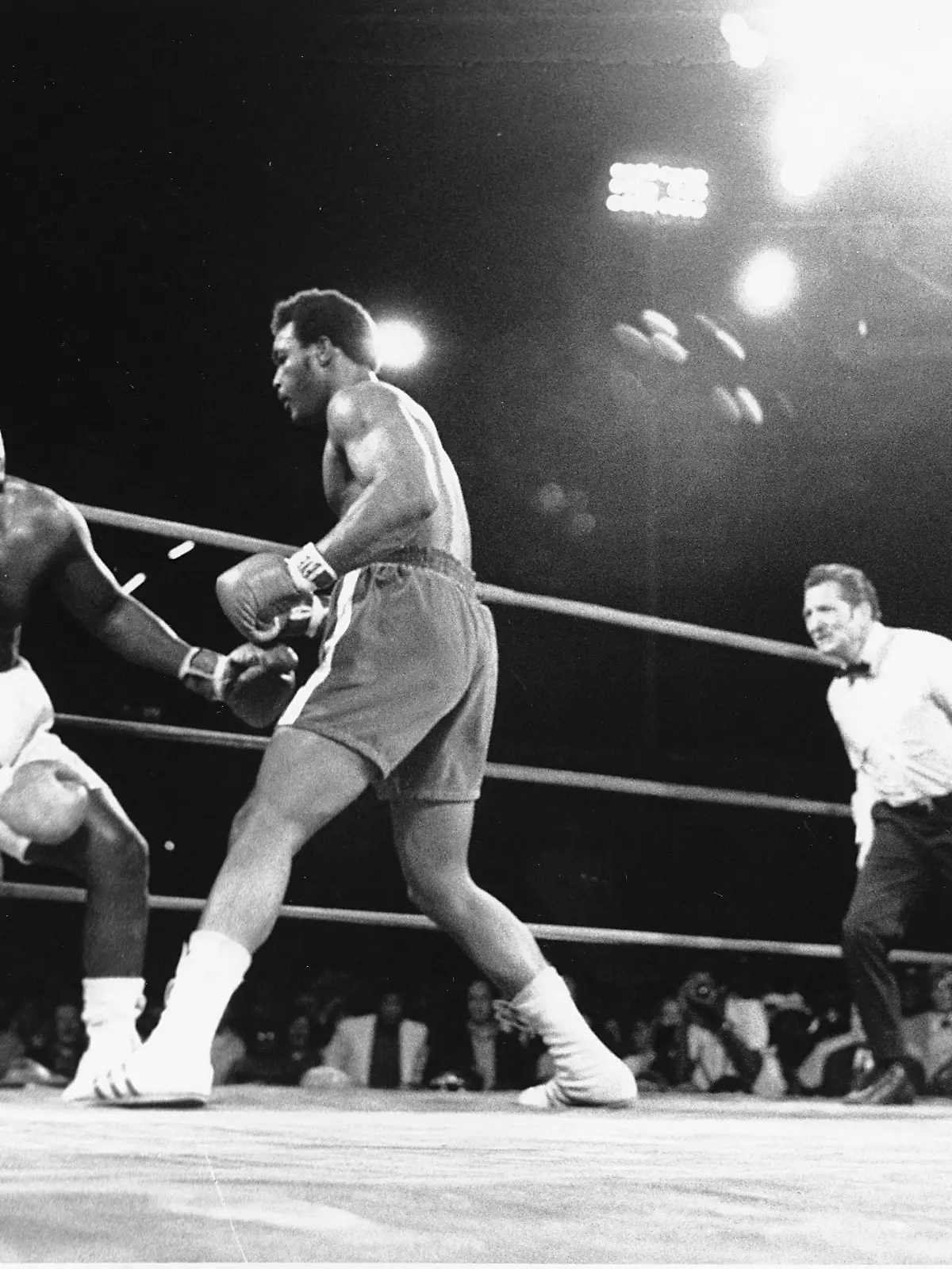 Heavyweight champion Joe Frazier, shown with blood coming from his mouth, starts falling after challenger George Foreman landed a hard right to the head in the second round of the fight in Kingston, Jamaica on Jan. 22, 1973. The World Heavyweight Championship title went to Foreman as the referee stopped the fight in the second round. (AP Photo)