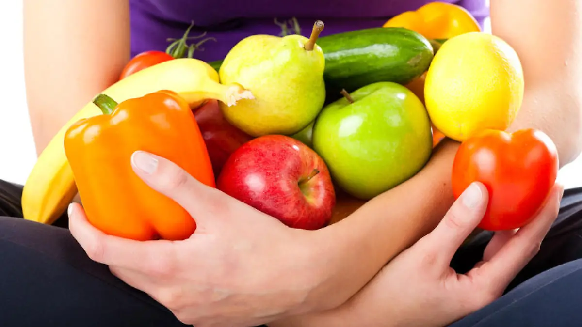Healthy eating, happy woman with fruits and vegetables, closed-up