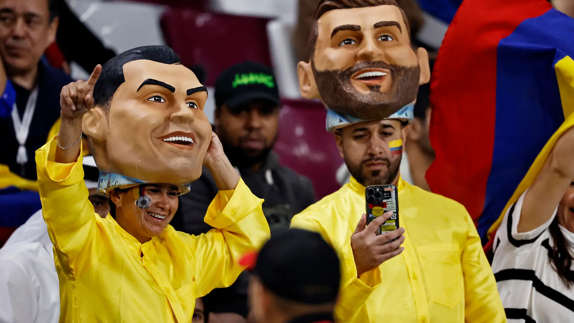 Soccer Football - FIFA World Cup Qatar 2022 - Third-Place Playoff - Croatia v Morocco - Khalifa International Stadium, Doha, Qatar - December 17, 2022 Fans are pictured wearing headpieces depicting Argentina's Lionel Messi and Portugal's Cristiano Ronaldo inside the stadium before the match REUTERS/Hamad I Mohammed