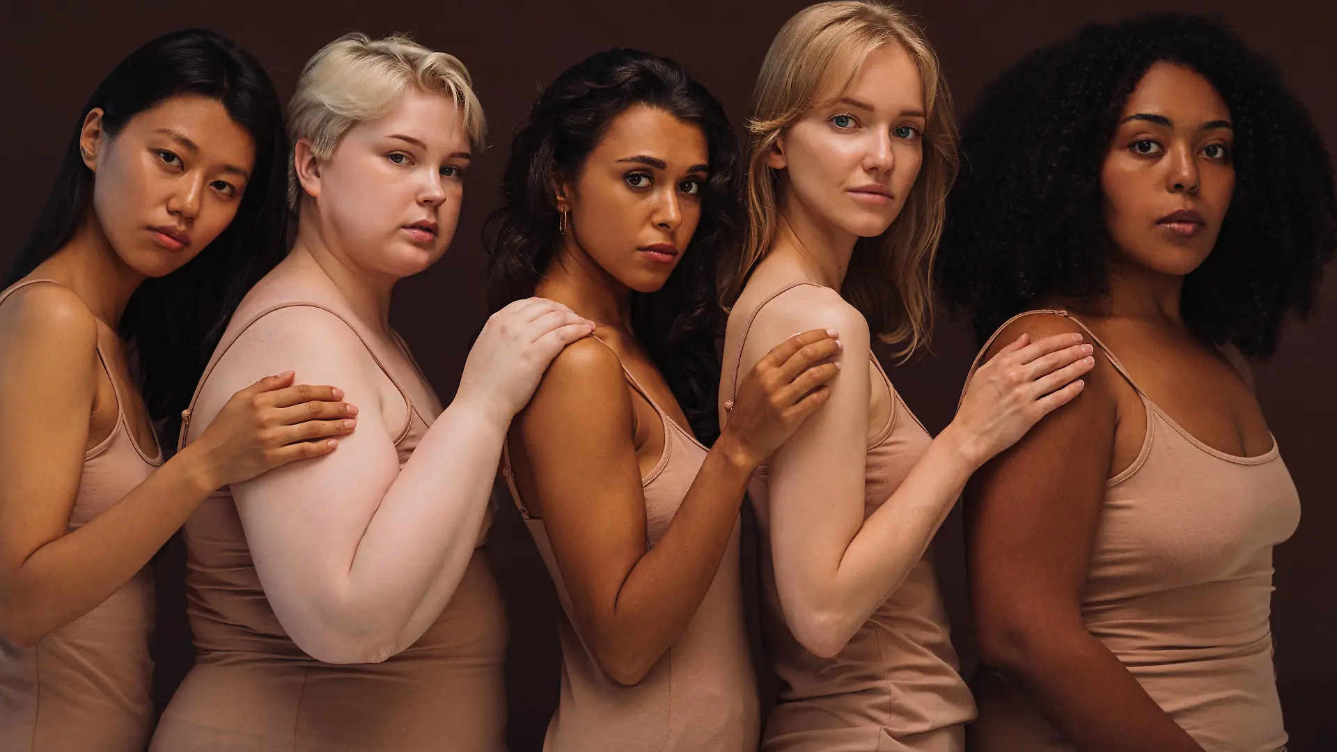  Group portrait of a young diverse women. Five females of different body types and races looking at camera in studio. Copyright: xxArtemxVarnitsinx 