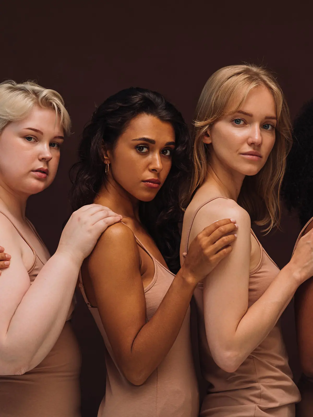  Group portrait of a young diverse women. Five females of different body types and races looking at camera in studio. Copyright: xxArtemxVarnitsinx 