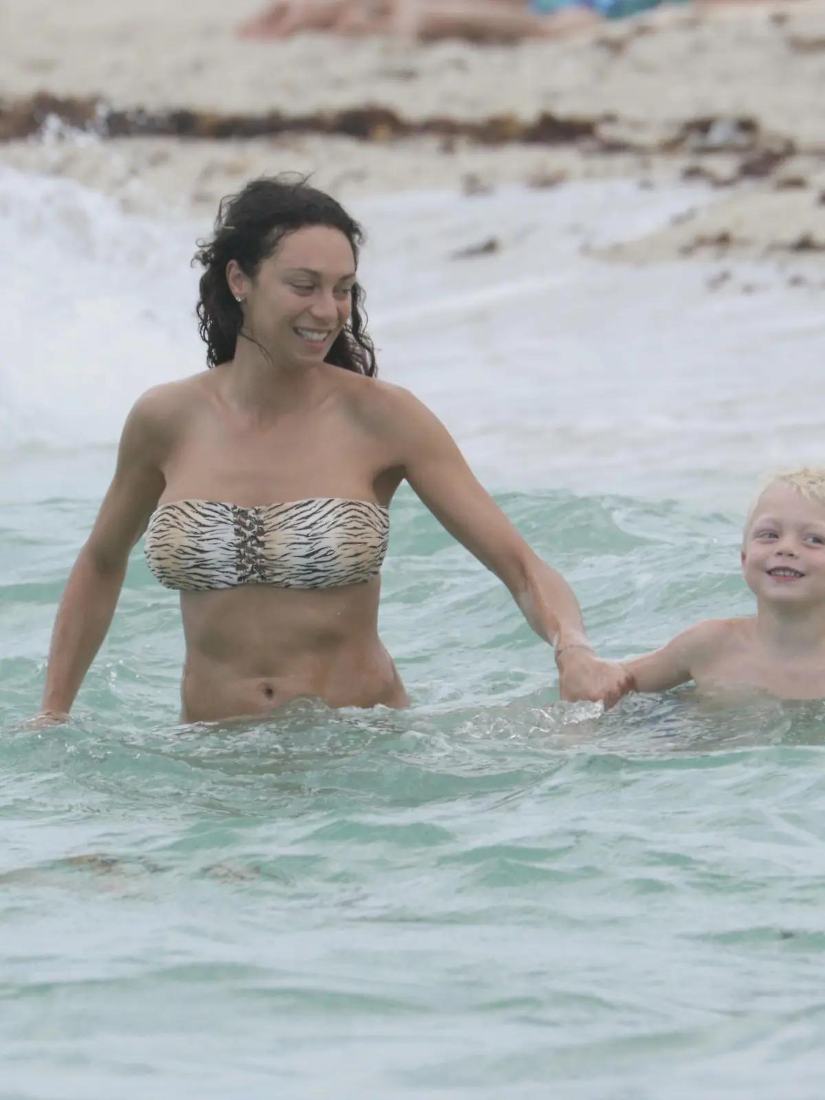 Model, Lilly Becker, and son, Amadeus, take a swim in the ocean in Miami Beach, FL. Lilly and Amadeus fought the waves while cooling off on a beach day. Amadeus wore colourful Vilebrequin swim trunks while his mother wore an animal print bandeau bikini.<P>Pictured: Lilly Becker and Amadeus Becker<B>Ref: SPL997536  120415  </B><BR/>Picture by: Pichichi/Splash News<BR/></P><P><B>Splash News and Pictures</B><BR/>Los Angeles:	310-821-2666<BR/>New York:	212-619-2666<BR/>London:	870-934-2666<BR/>photodesk@splashnews.com<BR/></P>