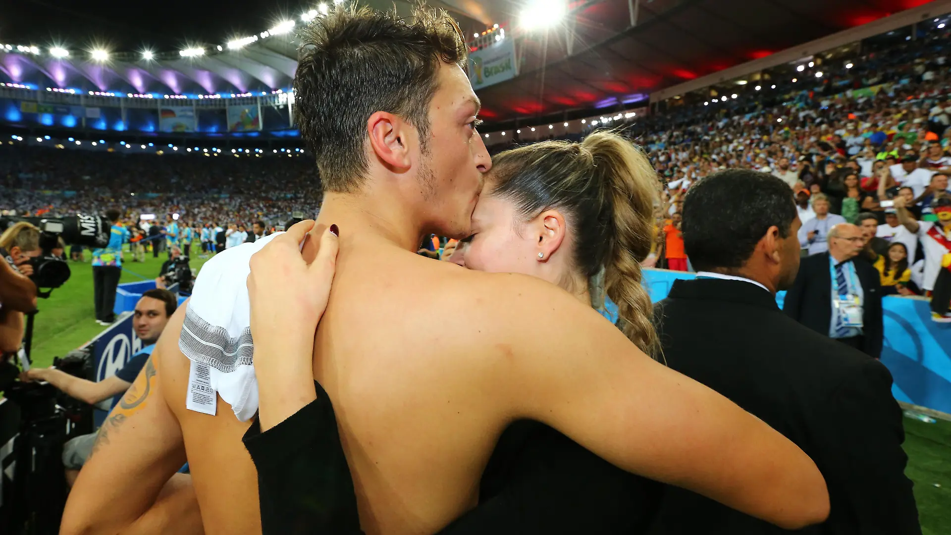 RIO DE JANEIRO, BRAZIL - JULY 13: Mesut Oezil of Germany celebrates with Mandy Capristo after defeating Argentina 1-0 in extra time during the 2014 FIFA World Cup Brazil Final match between Germany and Argentina at Maracana on July 13, 2014 in Rio de Janeiro, Brazil. (Photo by Martin Rose/Getty Images)