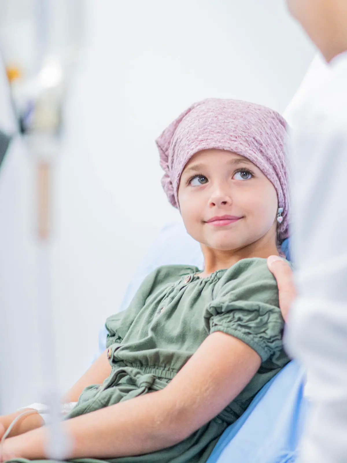 A little girl shares a smile with her female Doctor at her bedside