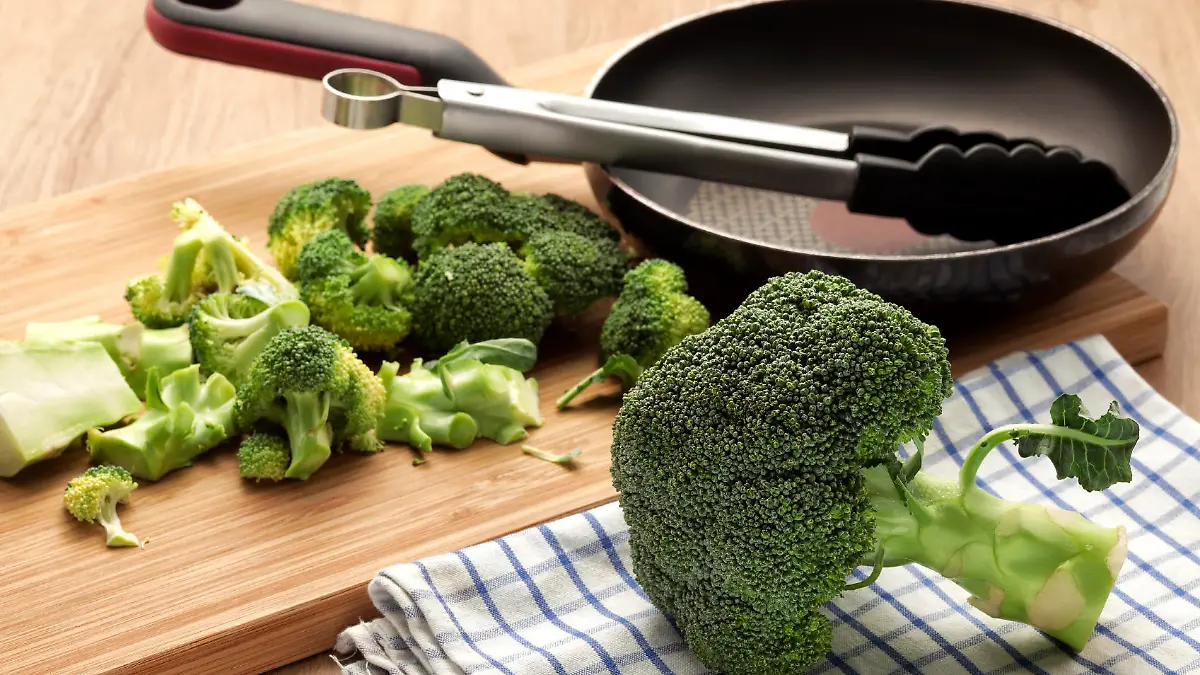 Broccoli for cooking with pan and wooden board