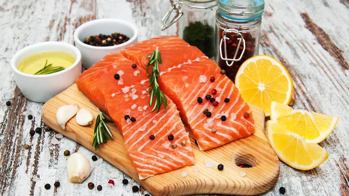 portions of fresh salmon fillet with aromatic herbs, spices and vegetables