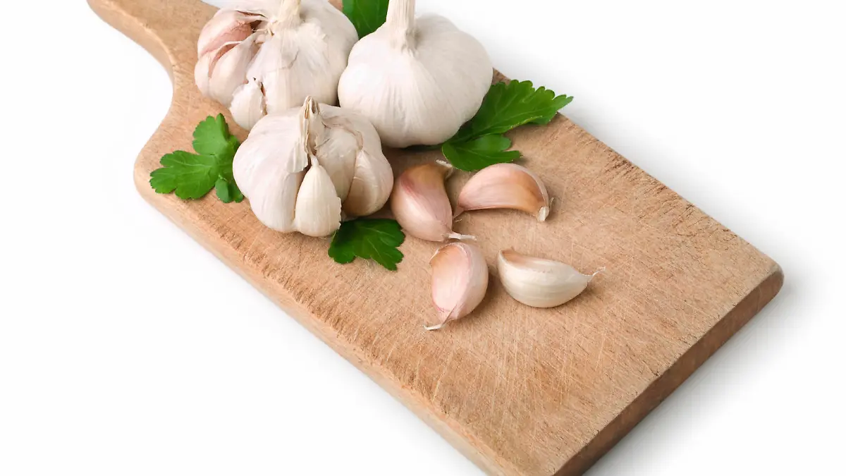 Garlic cloves on Cutting Board. This file includes clipping path.