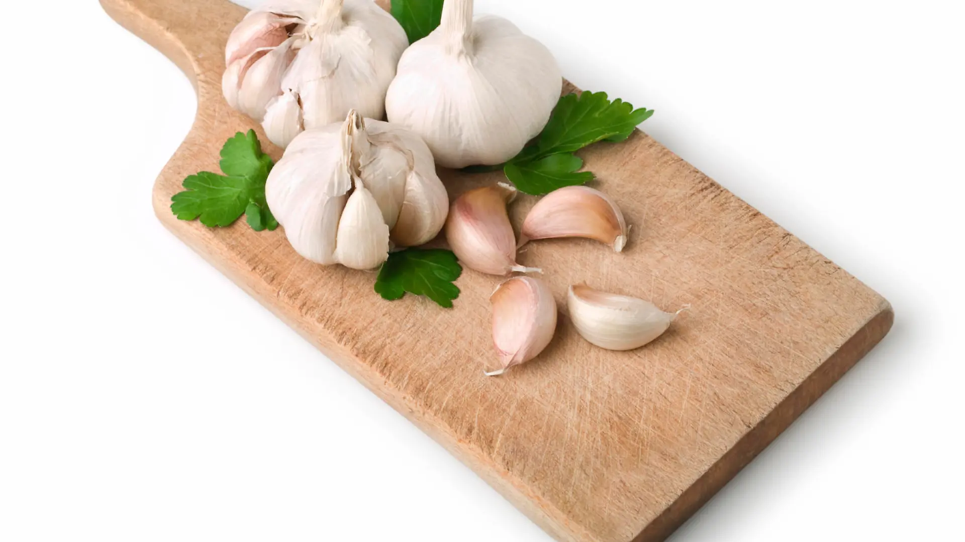 Garlic cloves on Cutting Board. This file includes clipping path.