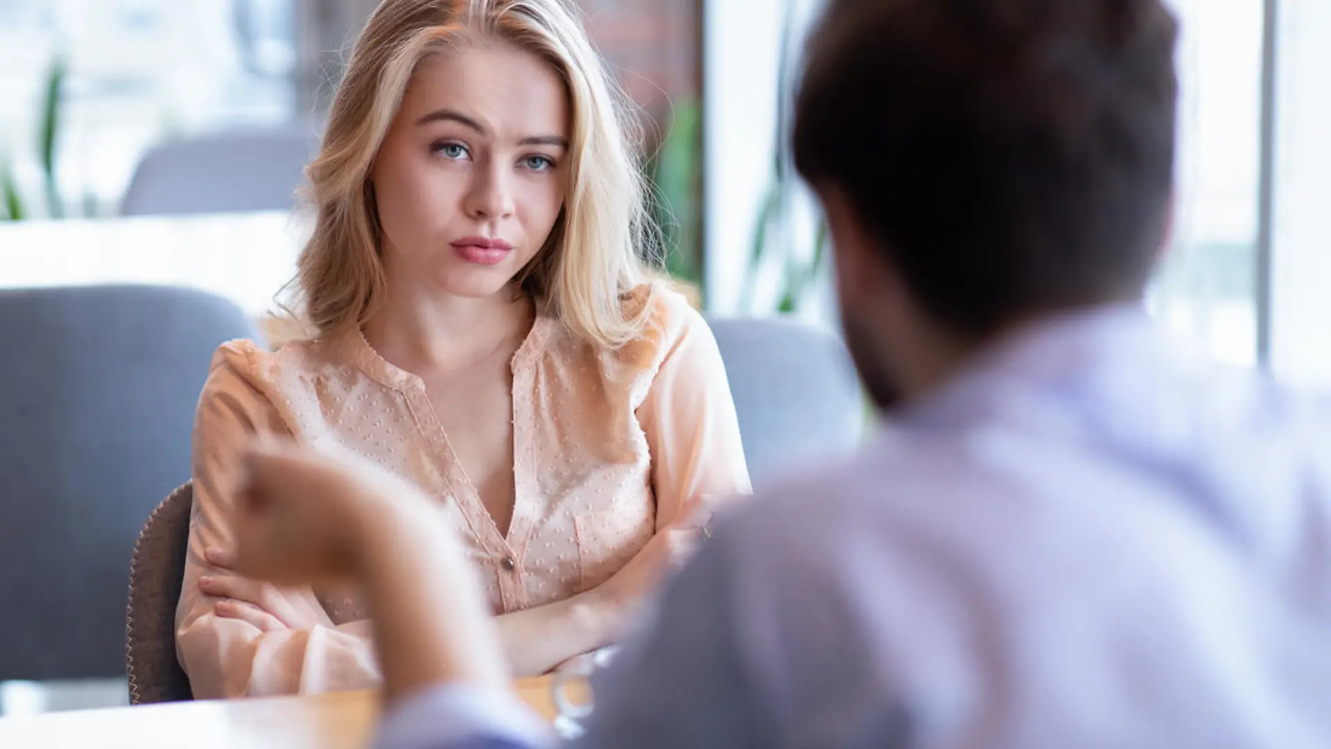 Bad date. Young woman feeling bored during dinner at cafe, unhappy with her boyfriend, disinterested in conversation. Stressed couple having difficulties in relationship, arguing in coffee shop