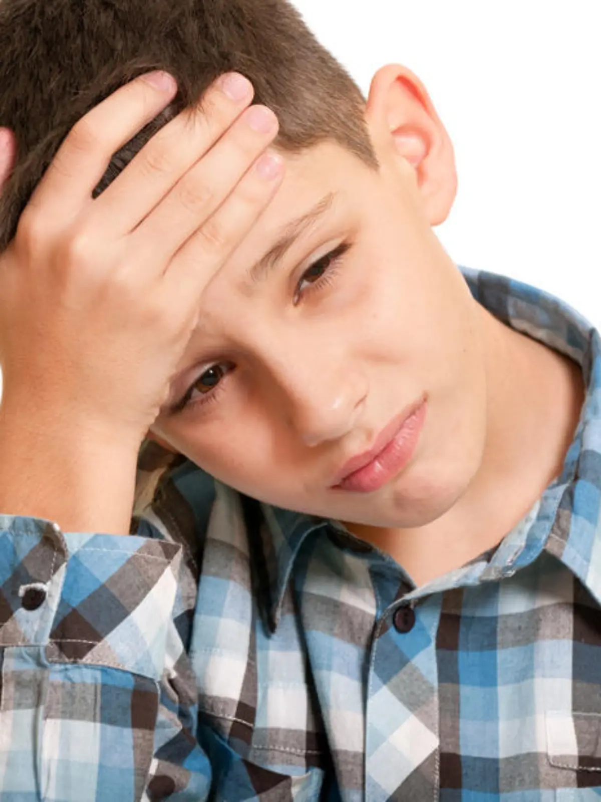 A closeup portrait of a sad boy holding his head with his hand; isolated on the white background